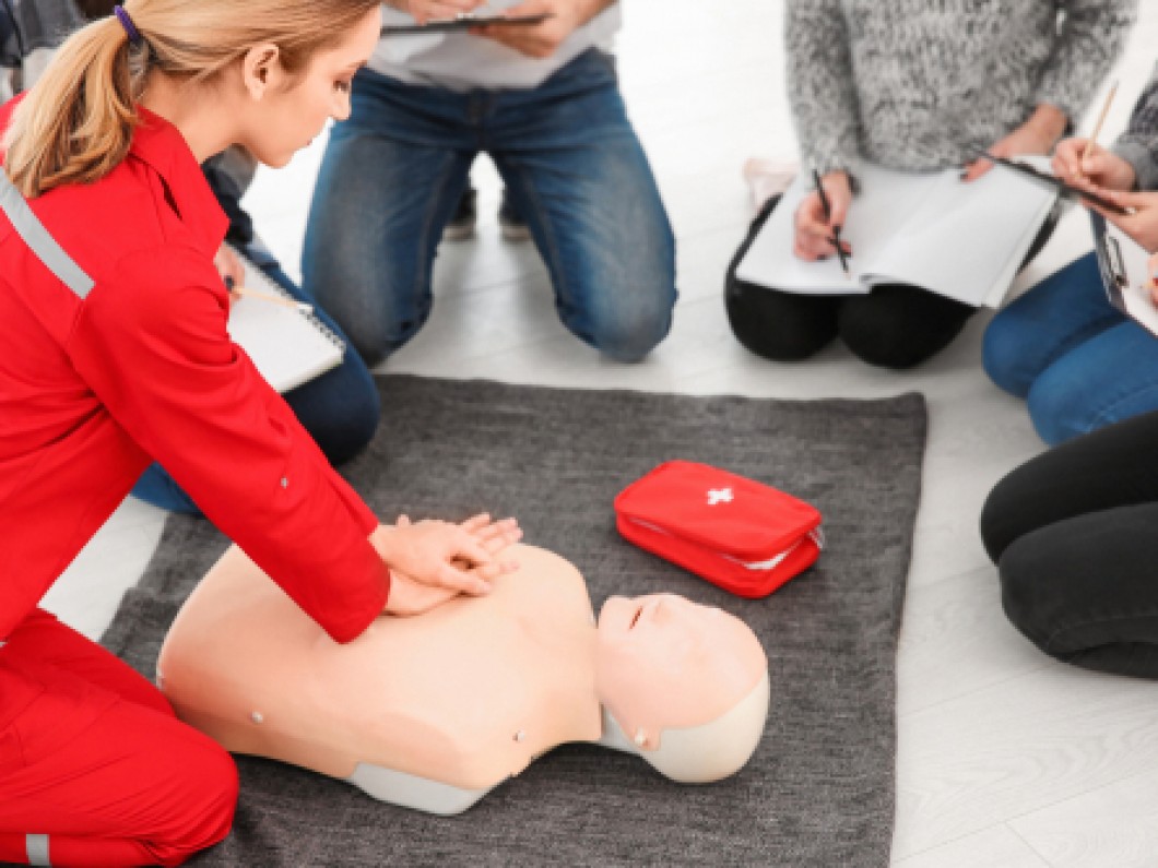 Woman demonstrating AHA Basic Life Support CPR Compressions